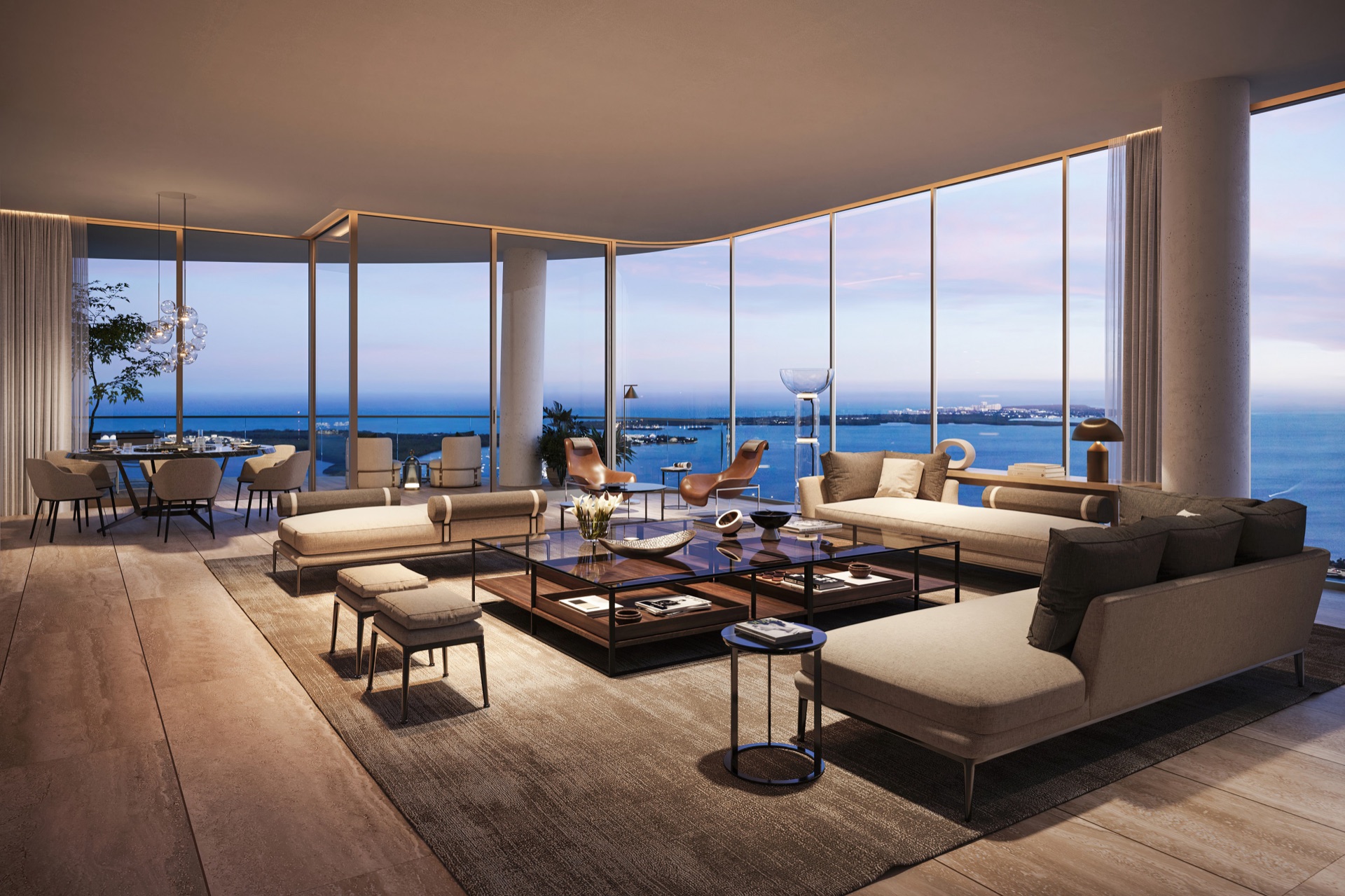 Great Room at dusk — floor-to-ceiling glass framing Biscayne Bay.
