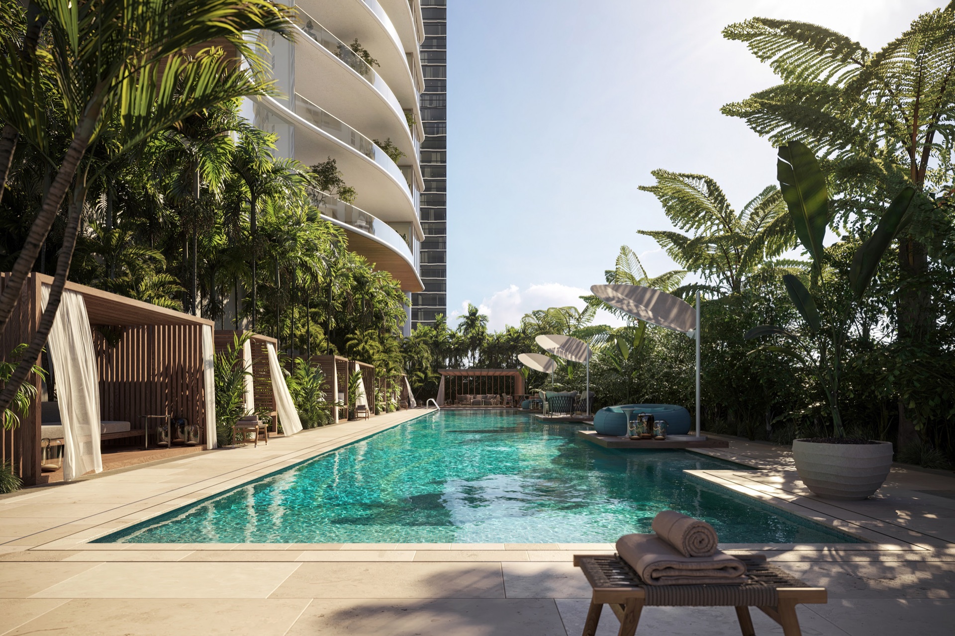 Resort-style pool with shallow wading area, poolside cabanas, and tropical gardens.